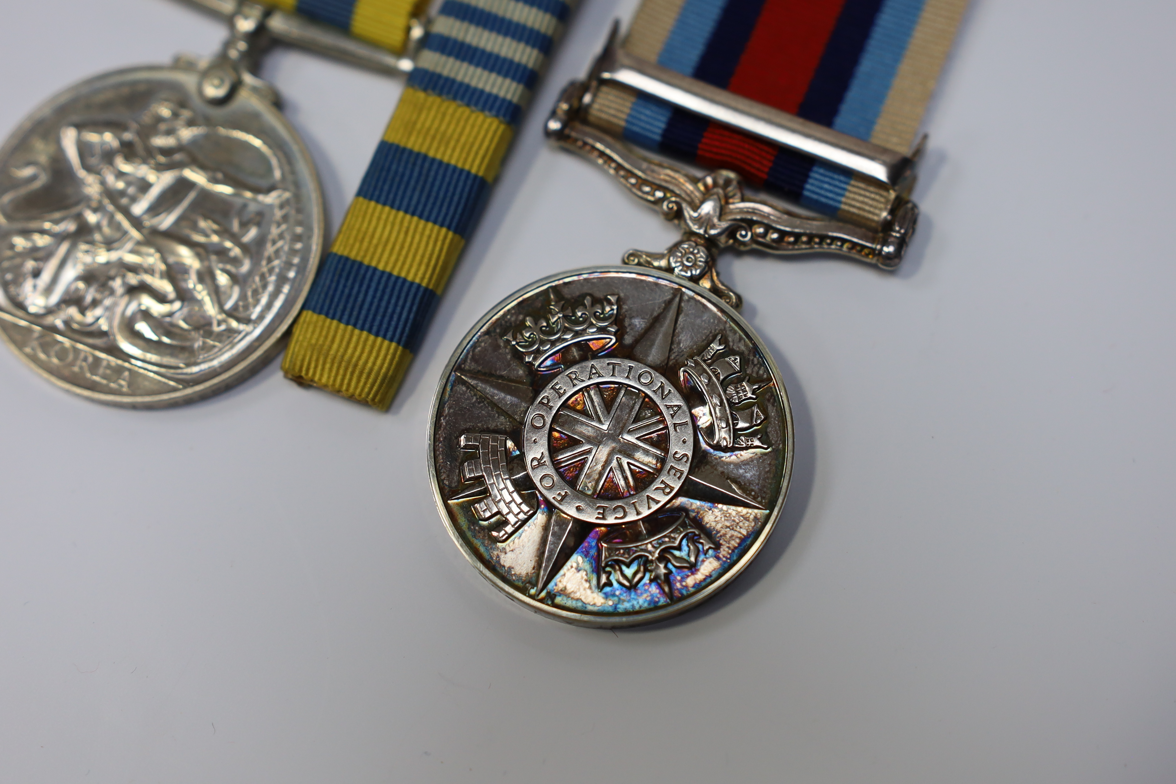 An ERII Operational Service Medal for Afghanistan awarded to Sgt. A.J. Pugsley RAMC (R), together with a Korea medal pair awarded to Sigmn. A.G. Lickman R.Sigs., all in separate issue boxes. Condition - fair to good